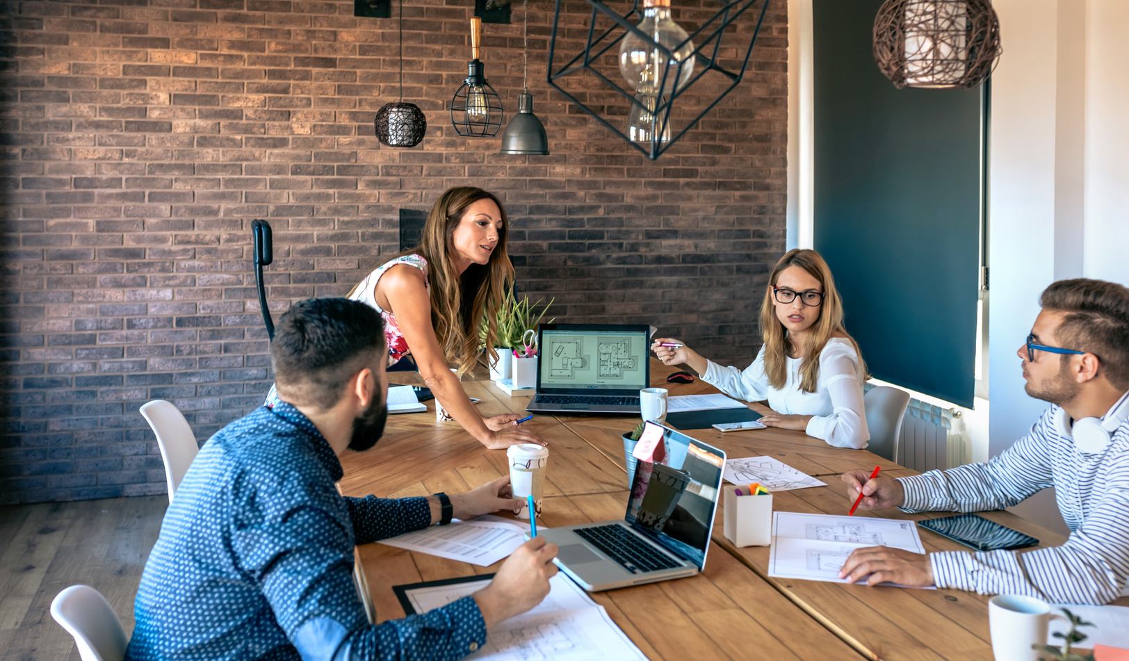 Female boss supervising work meeting