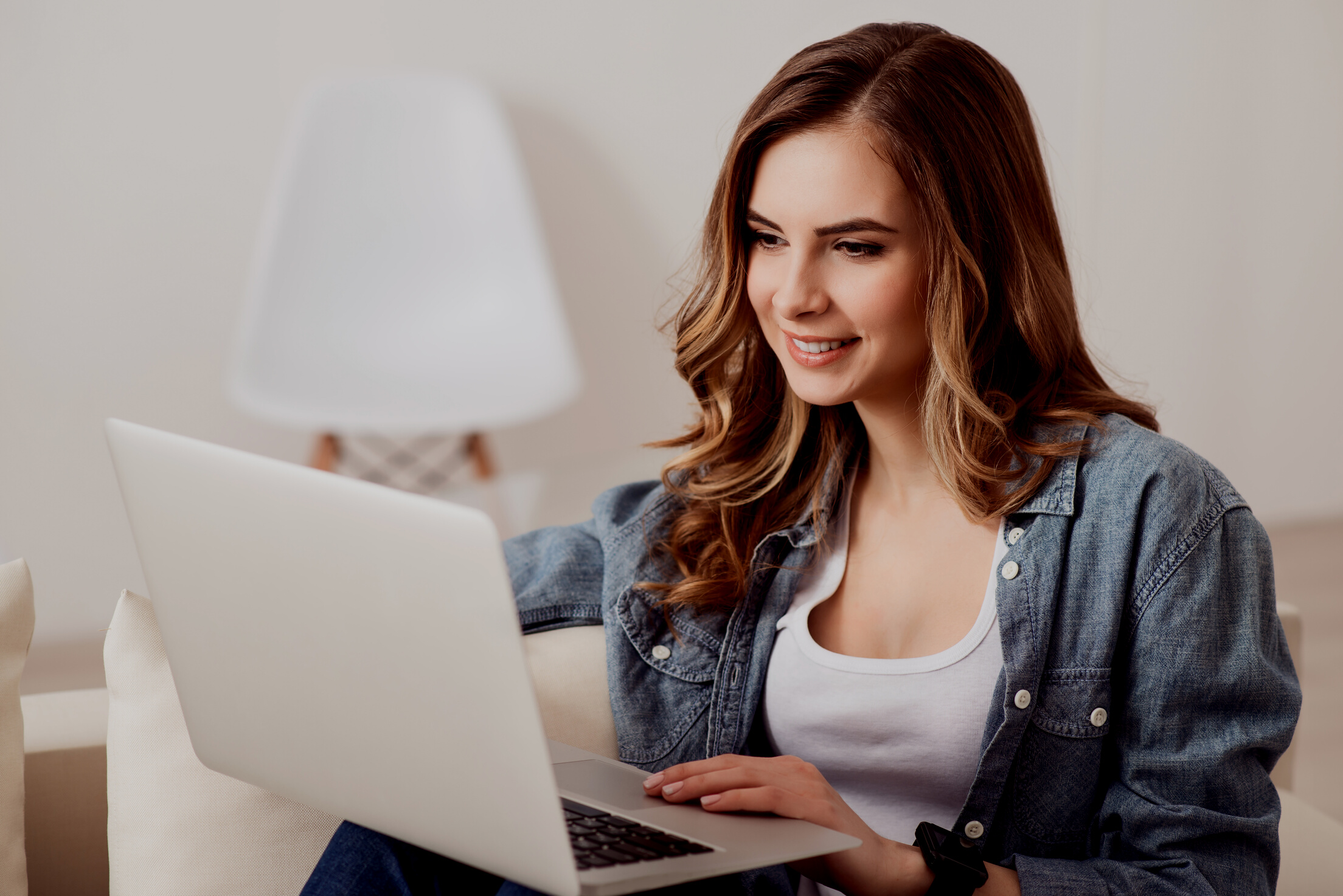 Cheerful beautiful girl using laptop